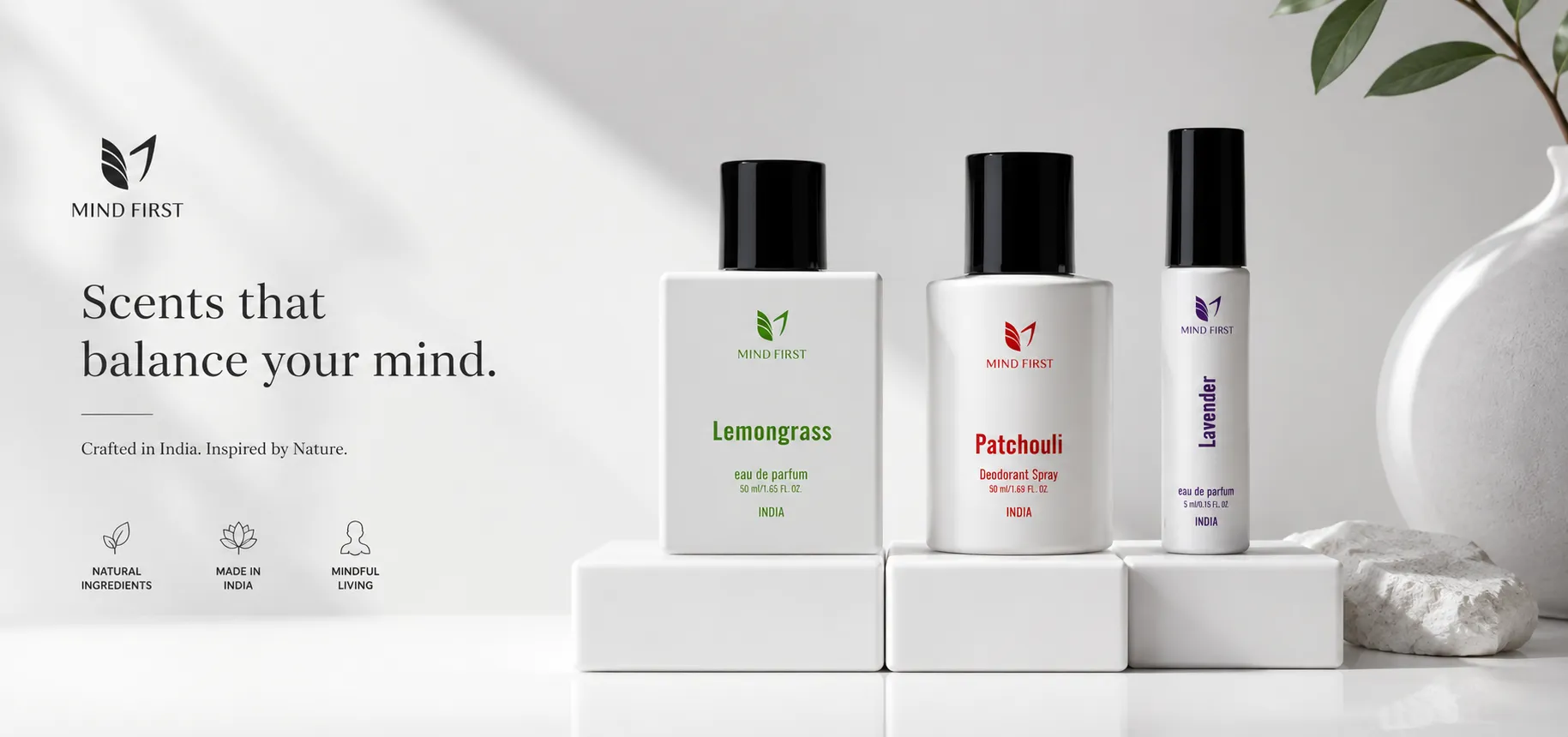 Mind First perfume trio on white blocks: Lemongrass, Patchouli, and Lavender eau de parfum with logo and the slogan 'Scents that balance your mind'.