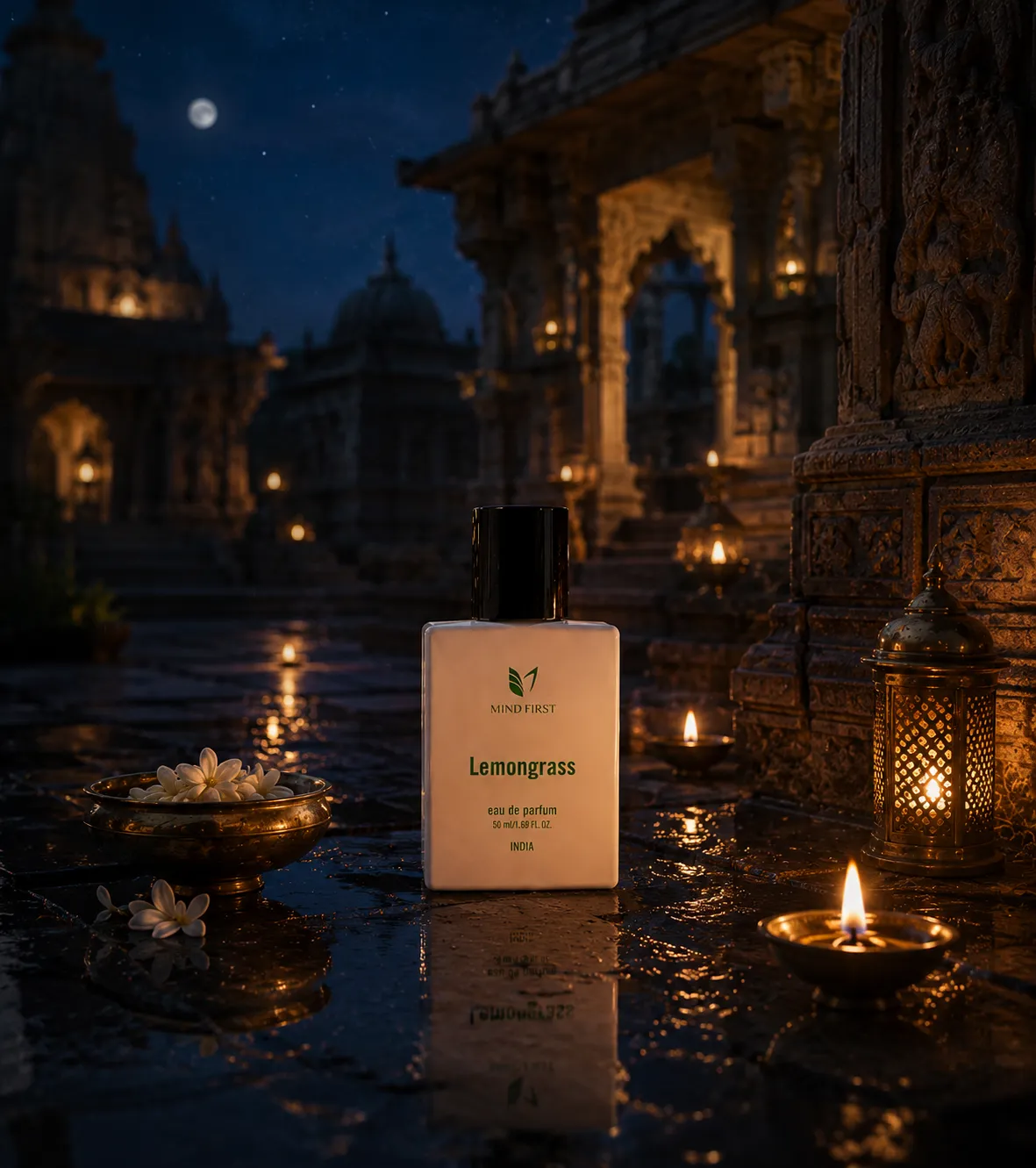 Perfume bottle labeled Lemongrass by Mind First on a wet temple floor, lit by small candles at night.