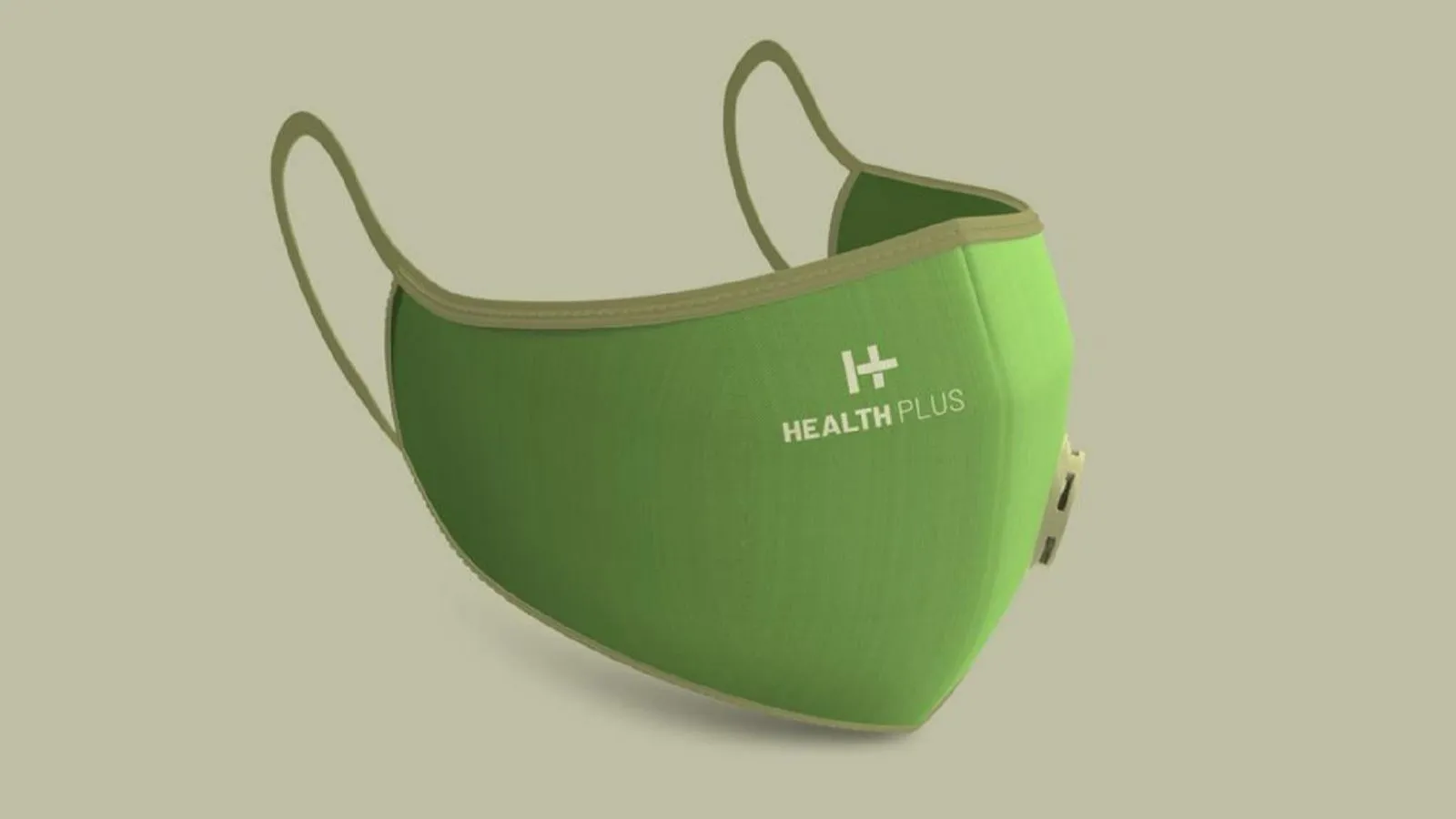 Green reusable face mask with beige edging and Health Plus logo on the front left side, ear loops visible behind.