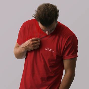 Man in a red t-shirt pulls at the chest, exposing the BRONCO logo on the shirt.
