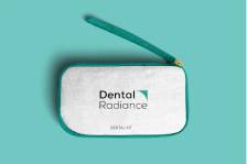White Dental Radiance whitening kit case on a teal background with a teal applicator resting above it.